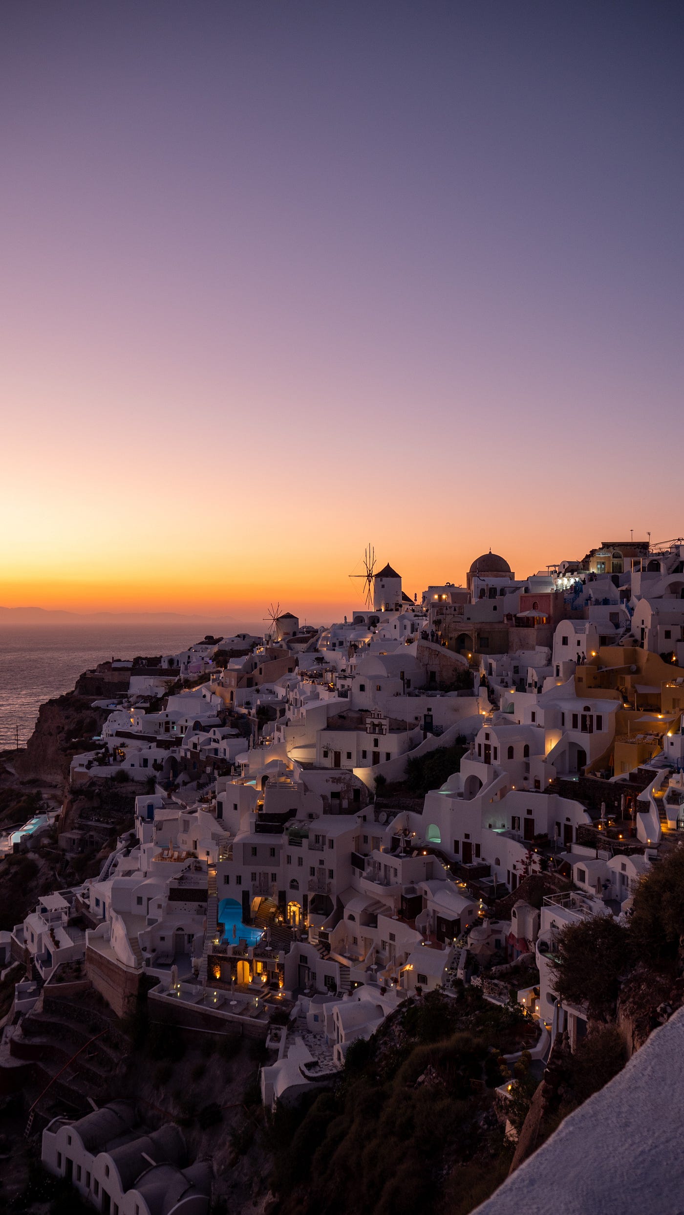 Which beach in Santorini is famous for its black volcanic sand?