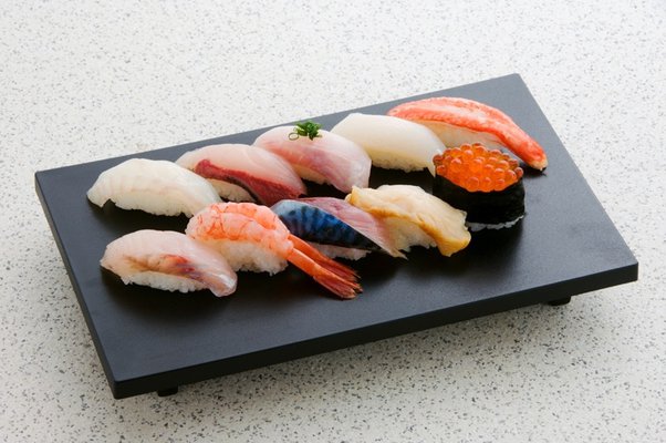 What is the purpose of wasabi in sushi and sashimi?