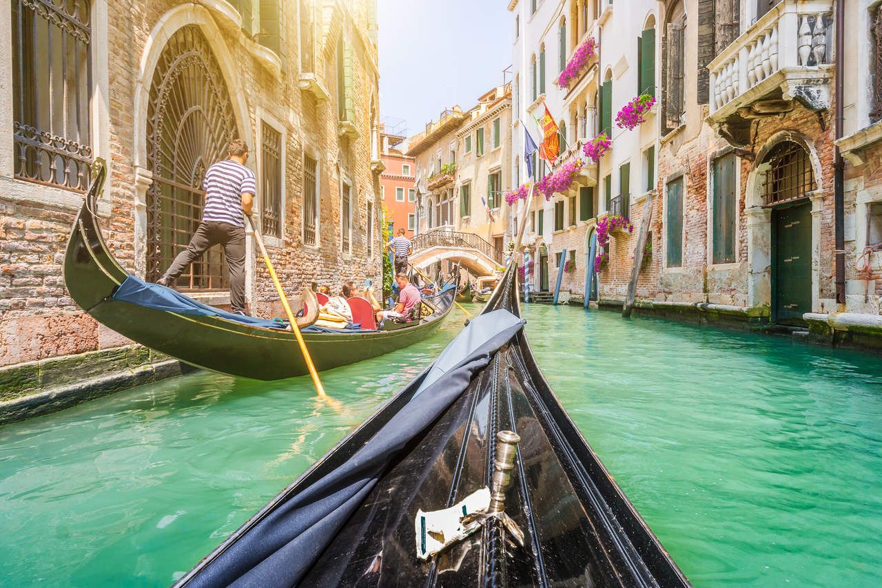 Which iconic Venetian boat is known for its unique shape and is used for transportation around the city?