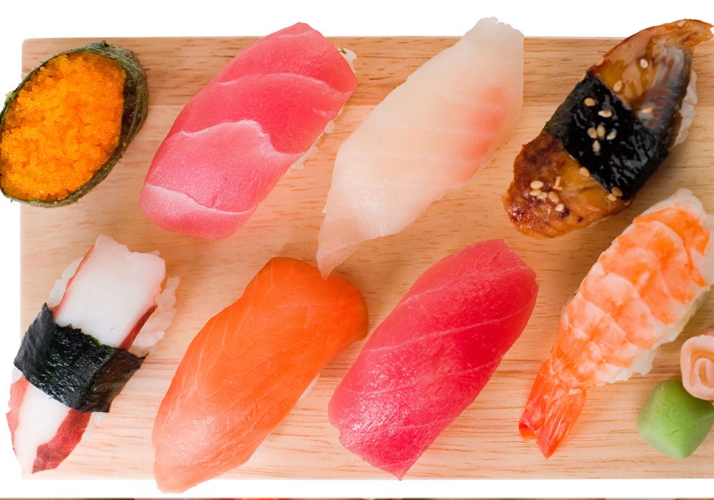 What is the traditional way of eating sushi?
