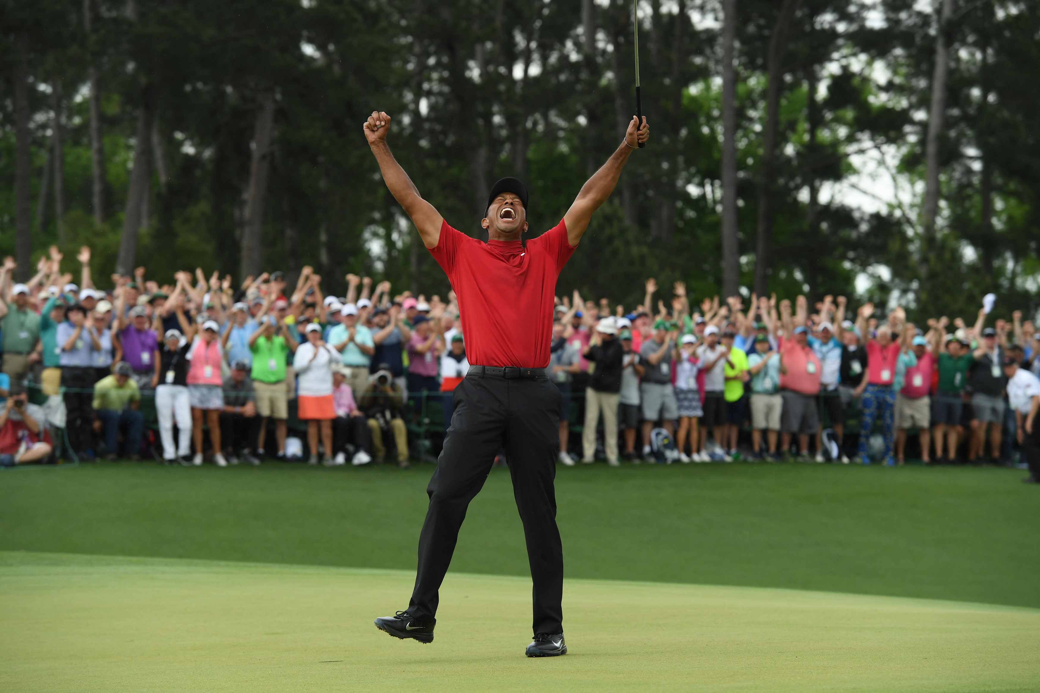 In which year did Tiger Woods complete the 'Tiger Slam' by winning all four major championships in a row?