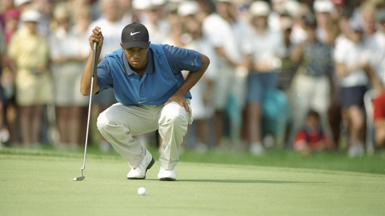 Which major championship did Tiger Woods win in his first full season on the PGA Tour?