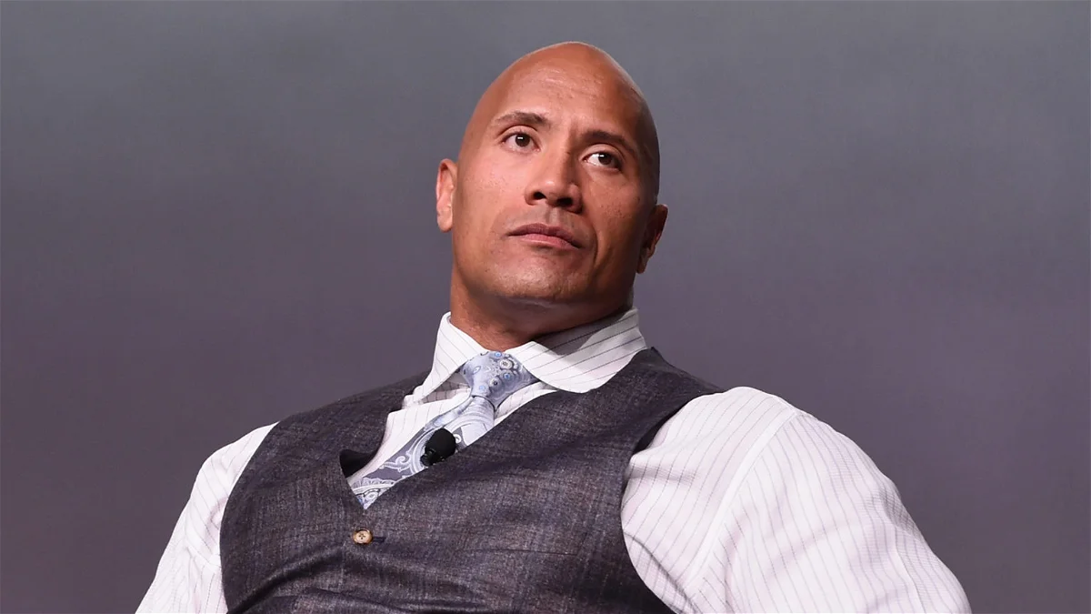 Which professional wrestling organization did The Rock become famous in?
