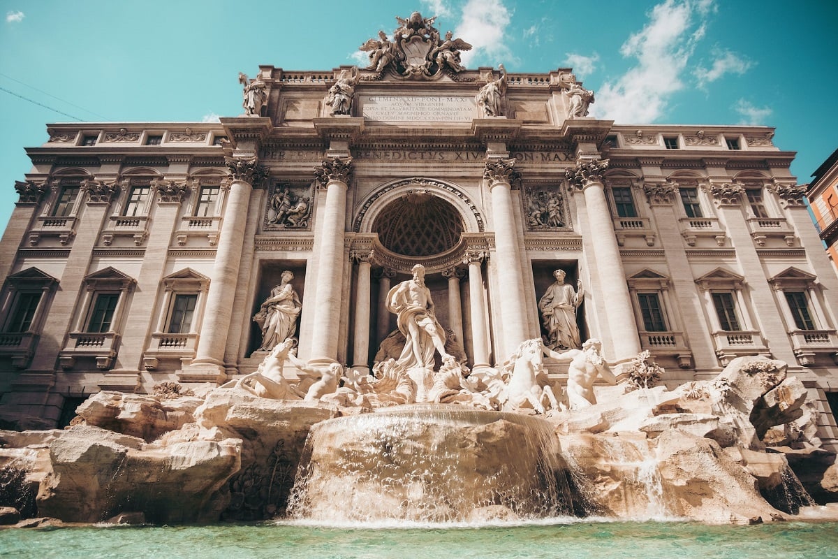 What is the name of the famous fountain in Rome where it is believed that if you toss a coin, you will return to Rome?
