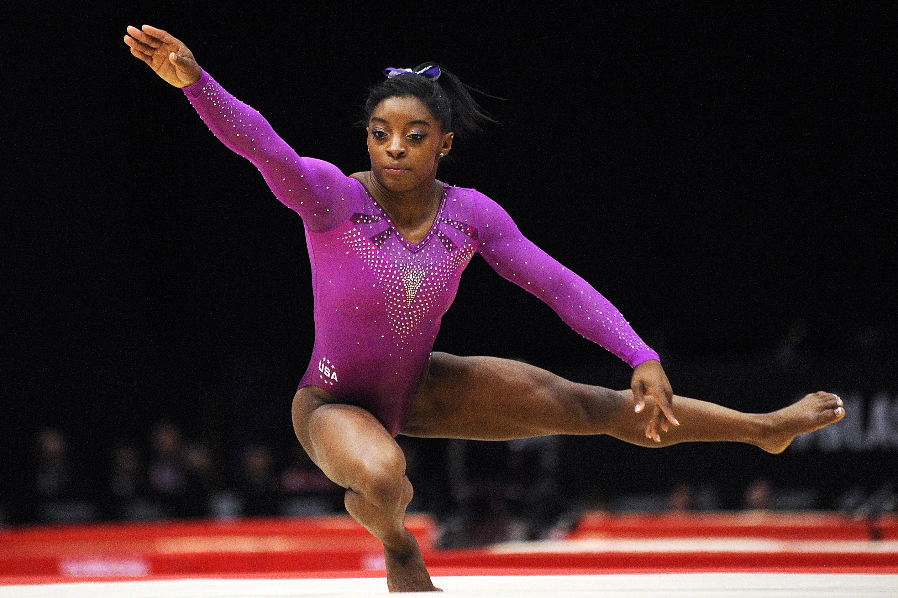 What is the name of the gymnastics move where the gymnast flips forward and twists at the same time?